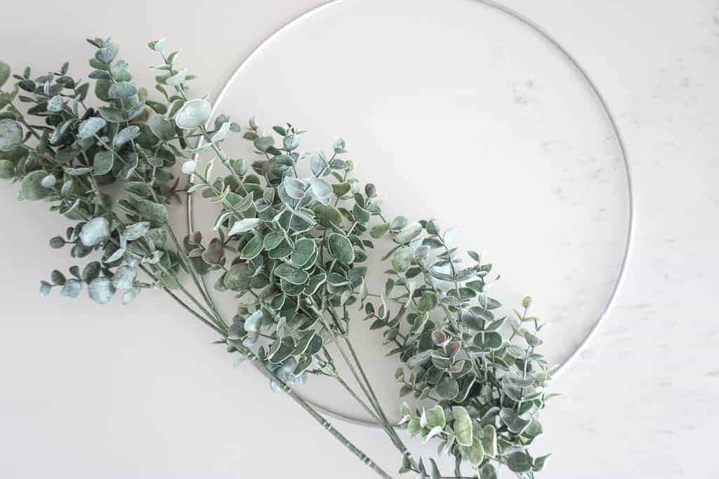 Signed Samantha's instructions on how to make a wreath step by step are included and limited items are needed. Pictured are two items including a thin circle in silver colour as well as some faux eucalyptus branches.