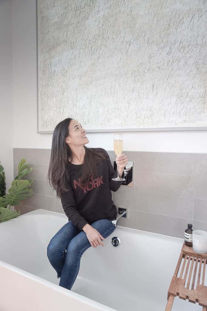 Signed Samantha sitting on the ledge of her bathtub admiring her D.I.Y Canvas Frame