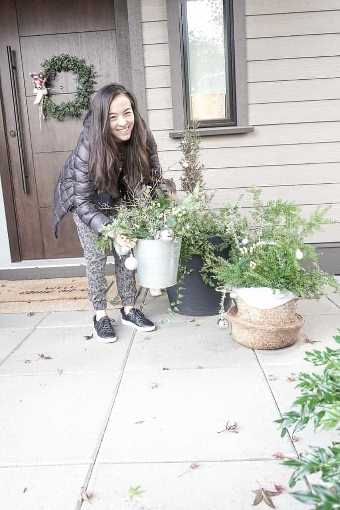 Signed Samantha shares her winter pot ideas. She is placing one of the green pots on the ground