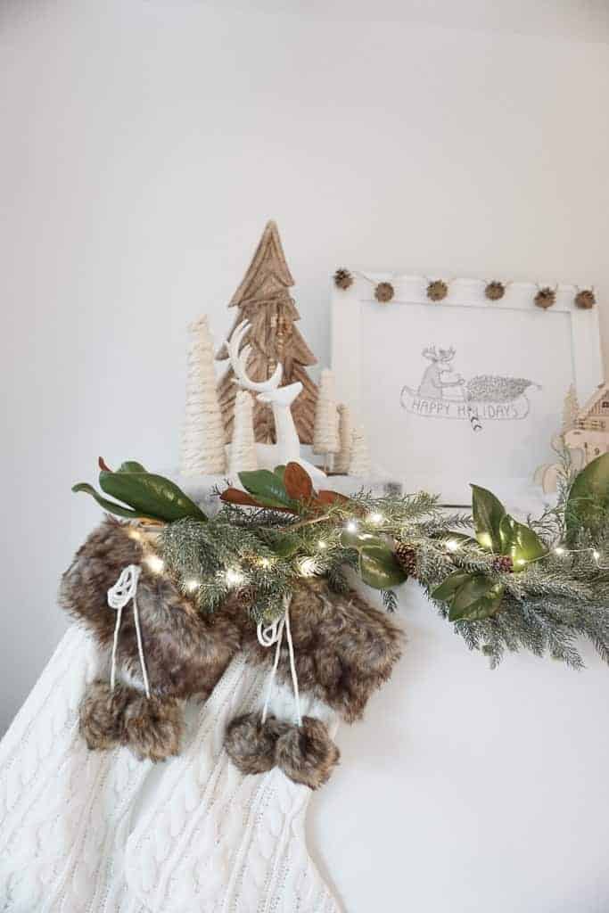 Signed Samantha's holiday mantle decor ideas includes beefing up your garland by using a combination of faux and real.
