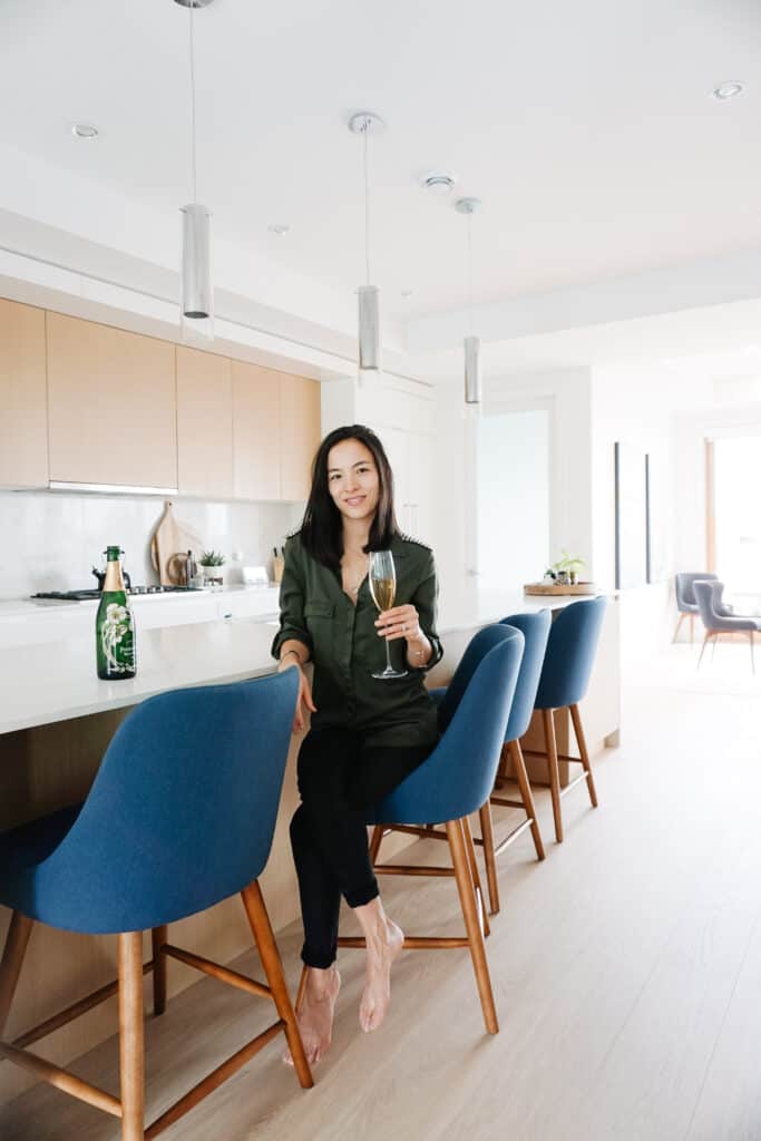 Signed Samantha shares her ideas for self improvement in 2021 as she sips a glass of champagne sitting at her kitchen island