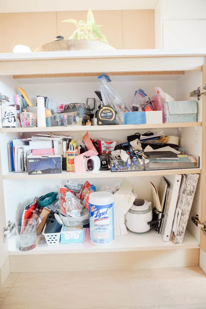 three things I want to organize includes this junk cupboard. It has such random things in it including pens, sloane's baby book, lysol wipes, a tape measure, post it notes, everything in it. It's another place of ogranized chaos.