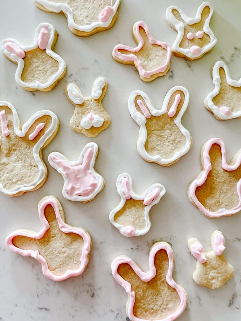 cute gluten-free sugar cookies shaped as bunny heads and decorated with pink and white icing