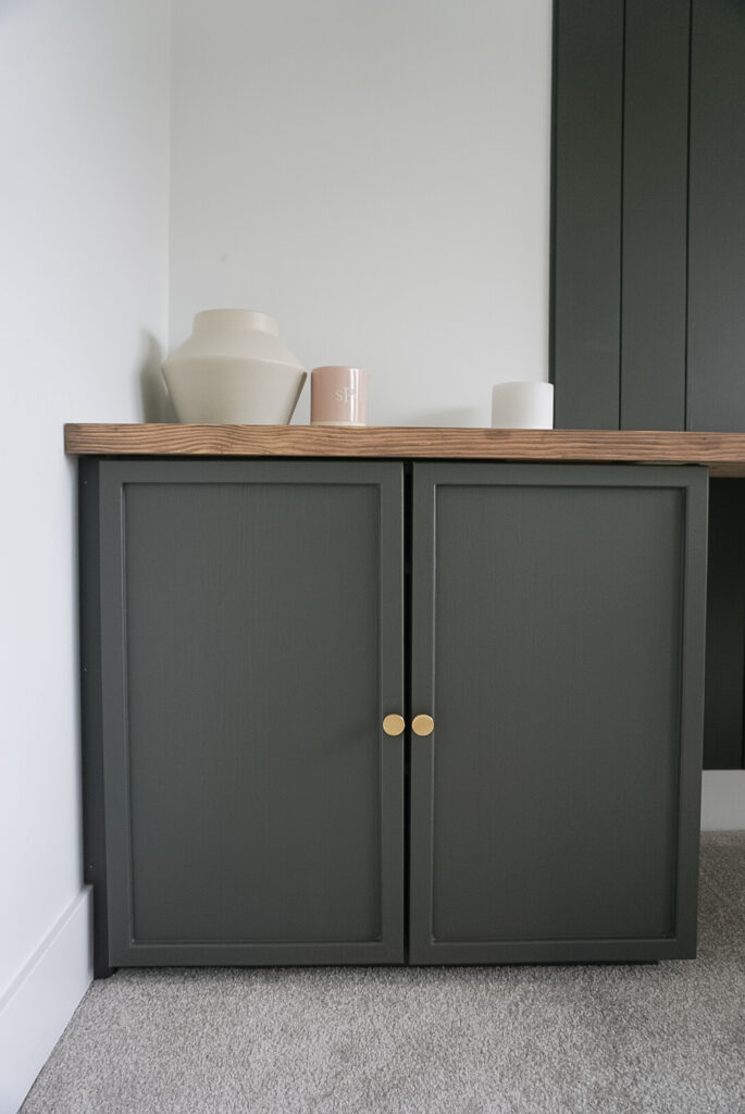 Ikea ivar cabinets but elevated by painted green with trim and hardware.