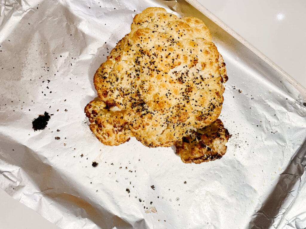 roasted cauliflower fresh from the oven on a tin foil lined tray