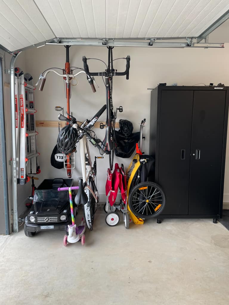 garage almost organized! bikes hanging on the wall, workout area ready to go