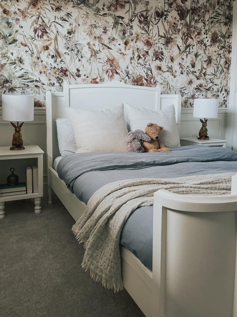 a sweet small spaces bedroom with white furniture and floral wallpaper and a bunny lamp from a canadian home decor store