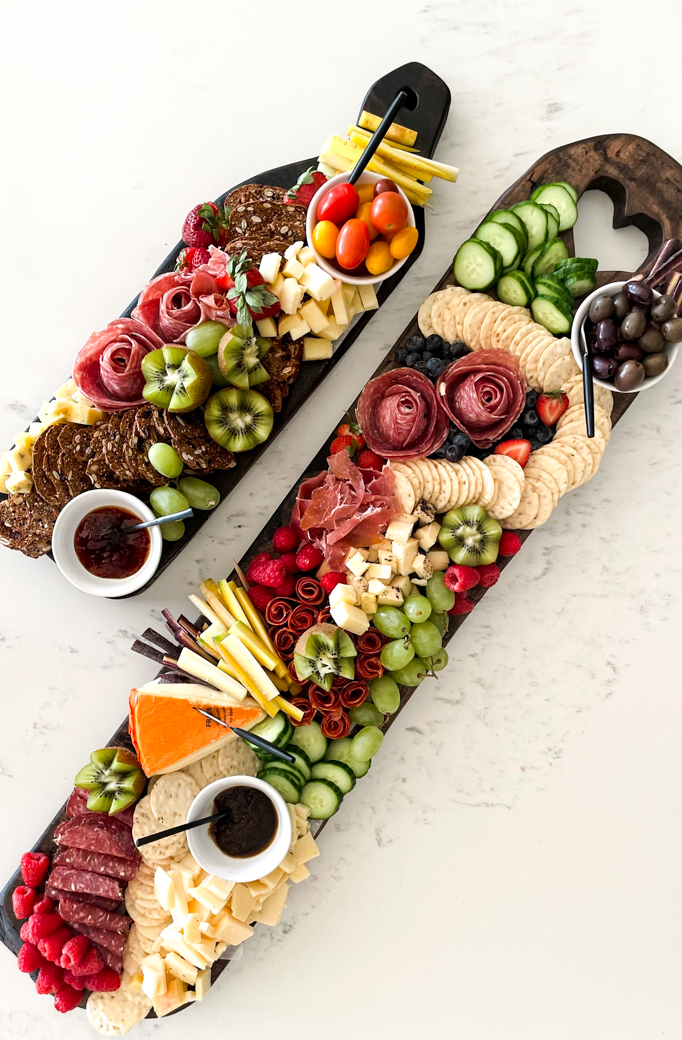 DIY holiday gifts including this DIY charcuterie board with lots of meats cheeses and crackers on it