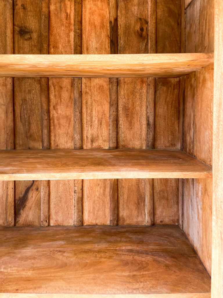 inside of the cabinet - shelfs with board and batten like detailing in the background