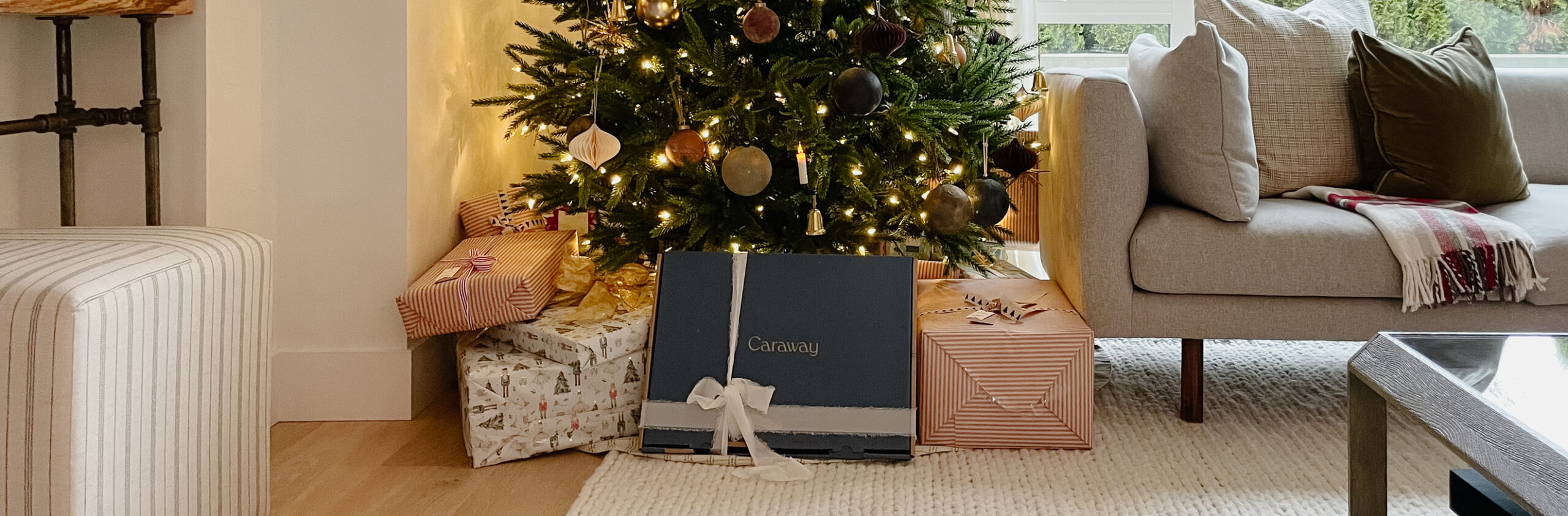 Last minute Christmas gift idea is a Caraway gift card - under a tree with several other presents.
