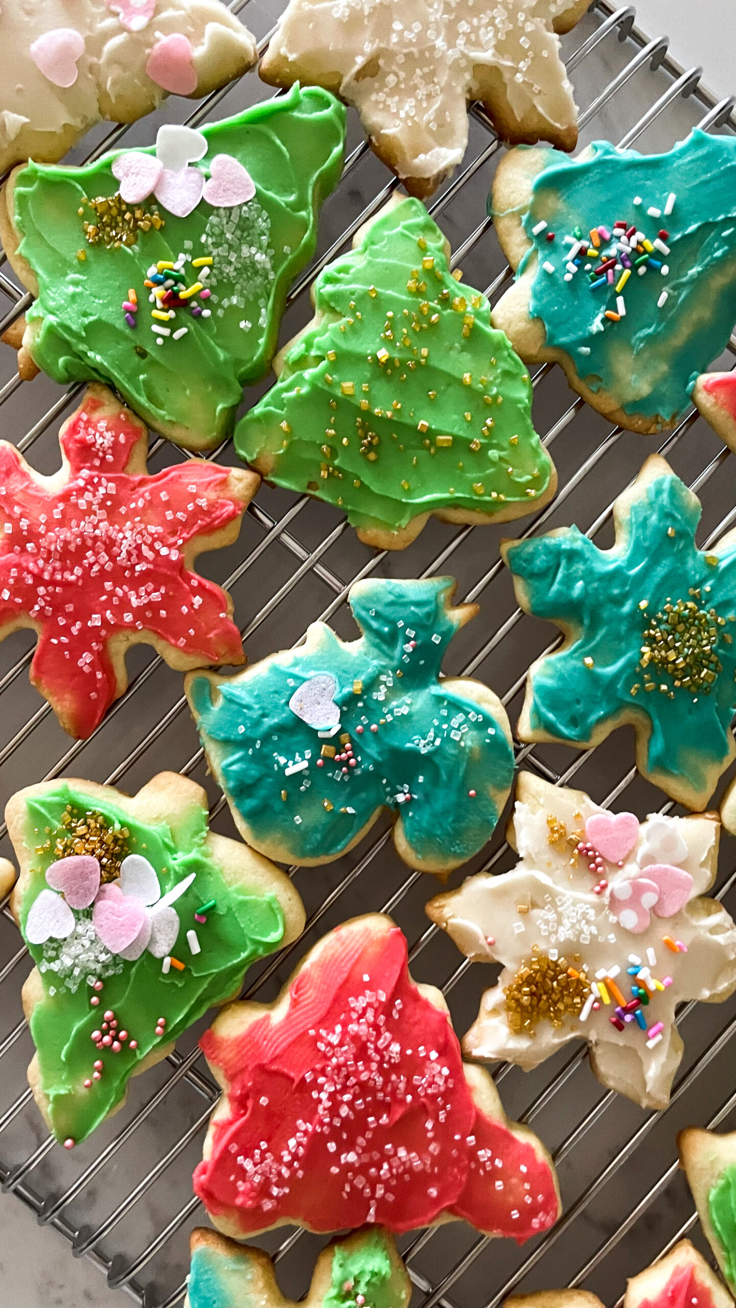 sugar cookies decorated for the holidays. Trees stars, squirrels, all in different colours.