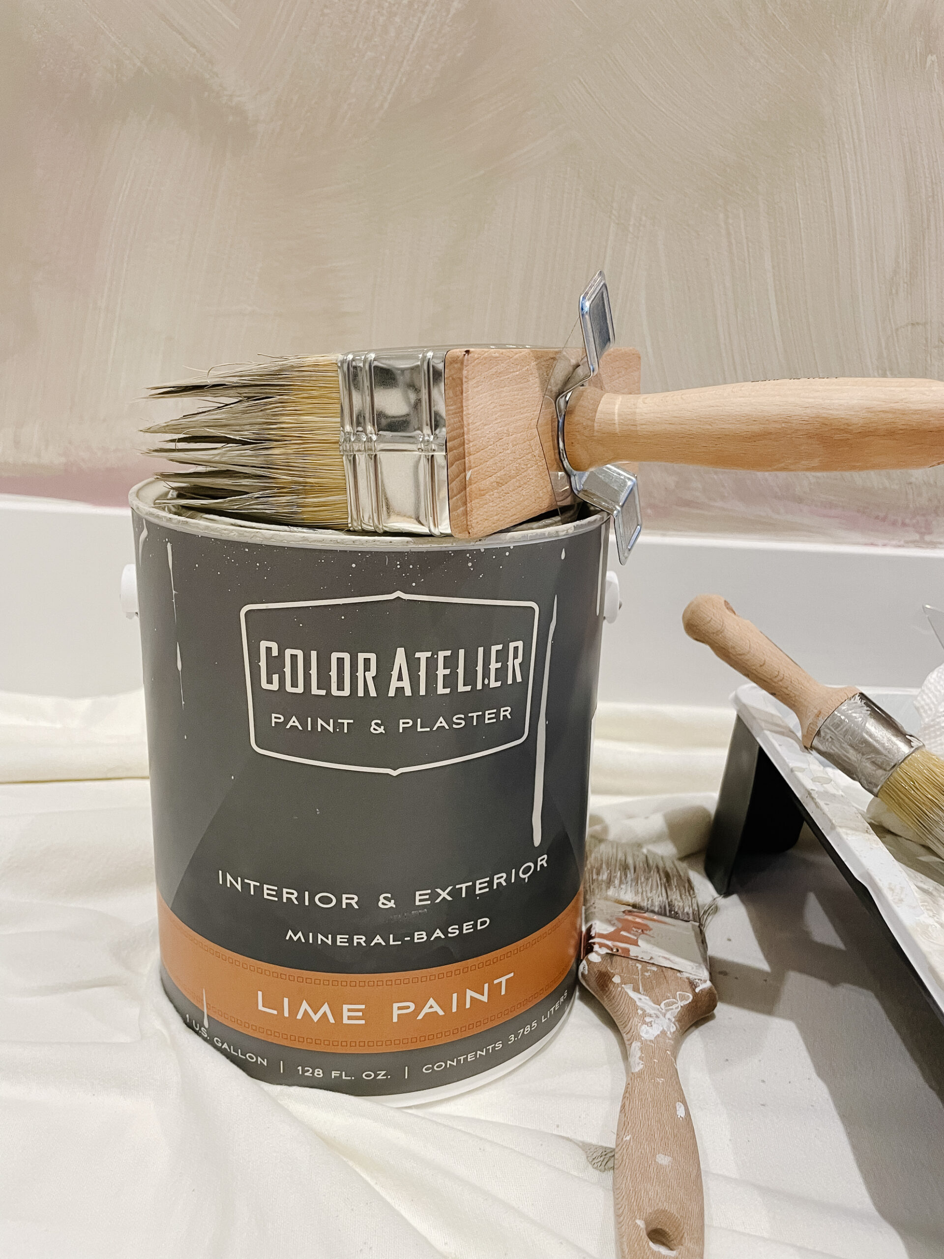 lime wash can of paint and brush