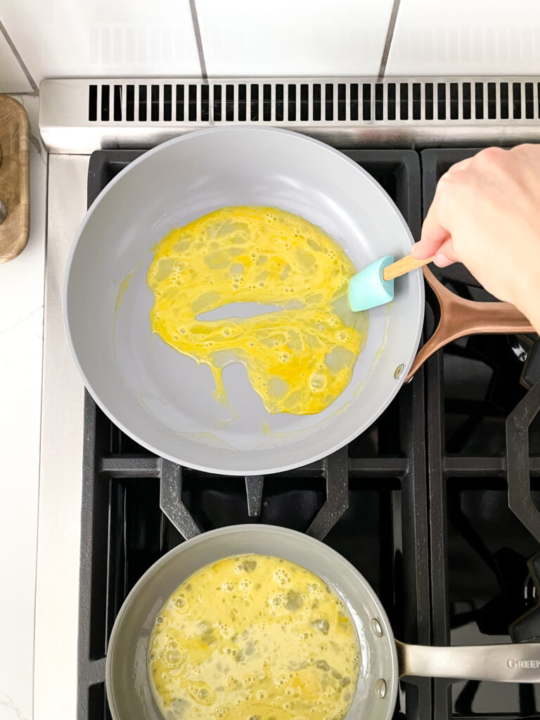 eggs cooking in both caraway and green pan