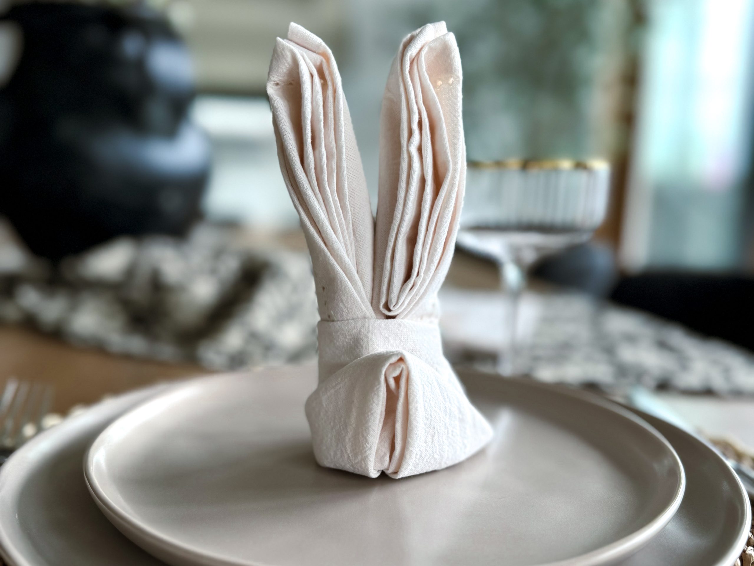 Easter bunny napkin - ears and tail on top of a plate
