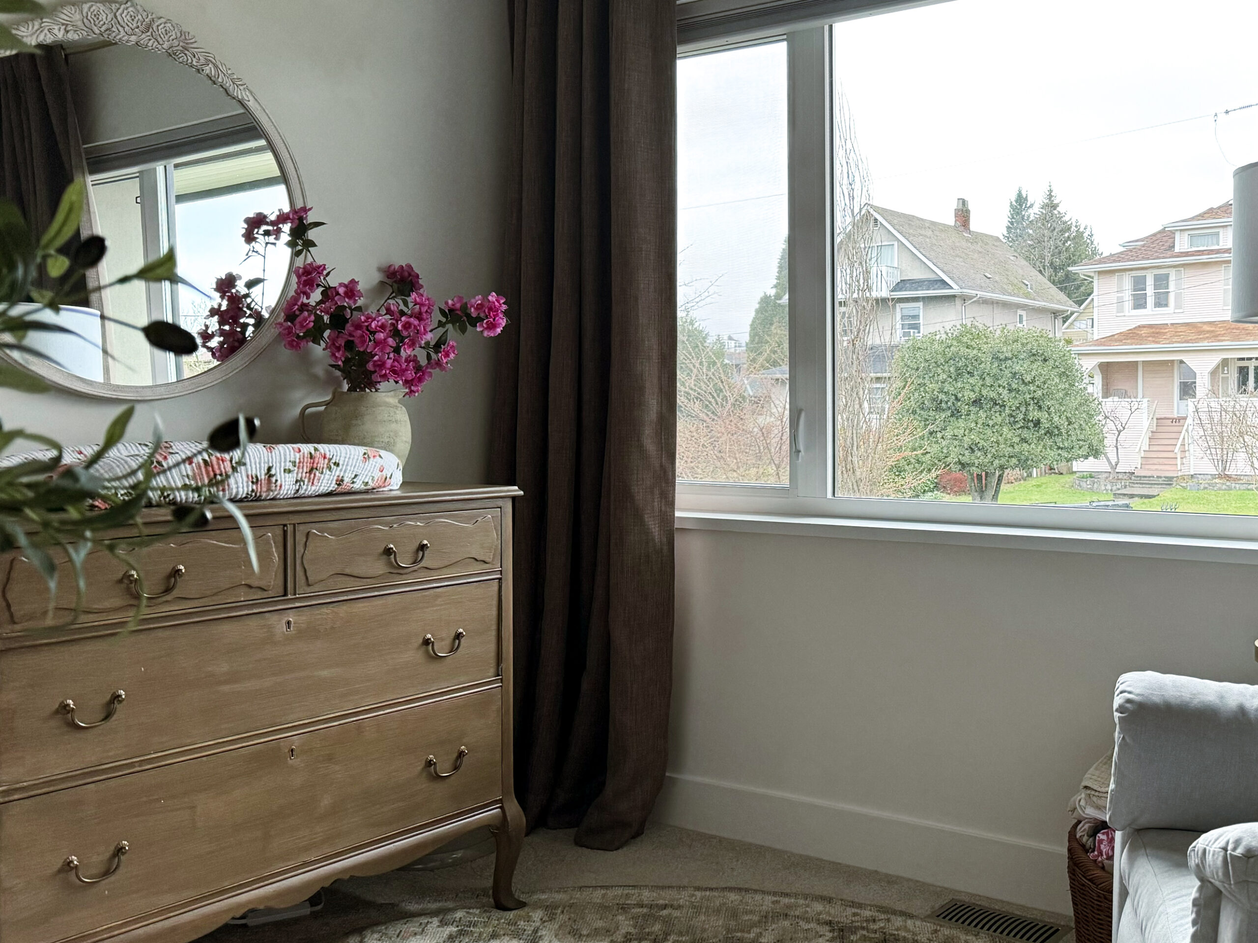 Making your curtains look expensive - a nursery with brown curtains and a dresser as a change table