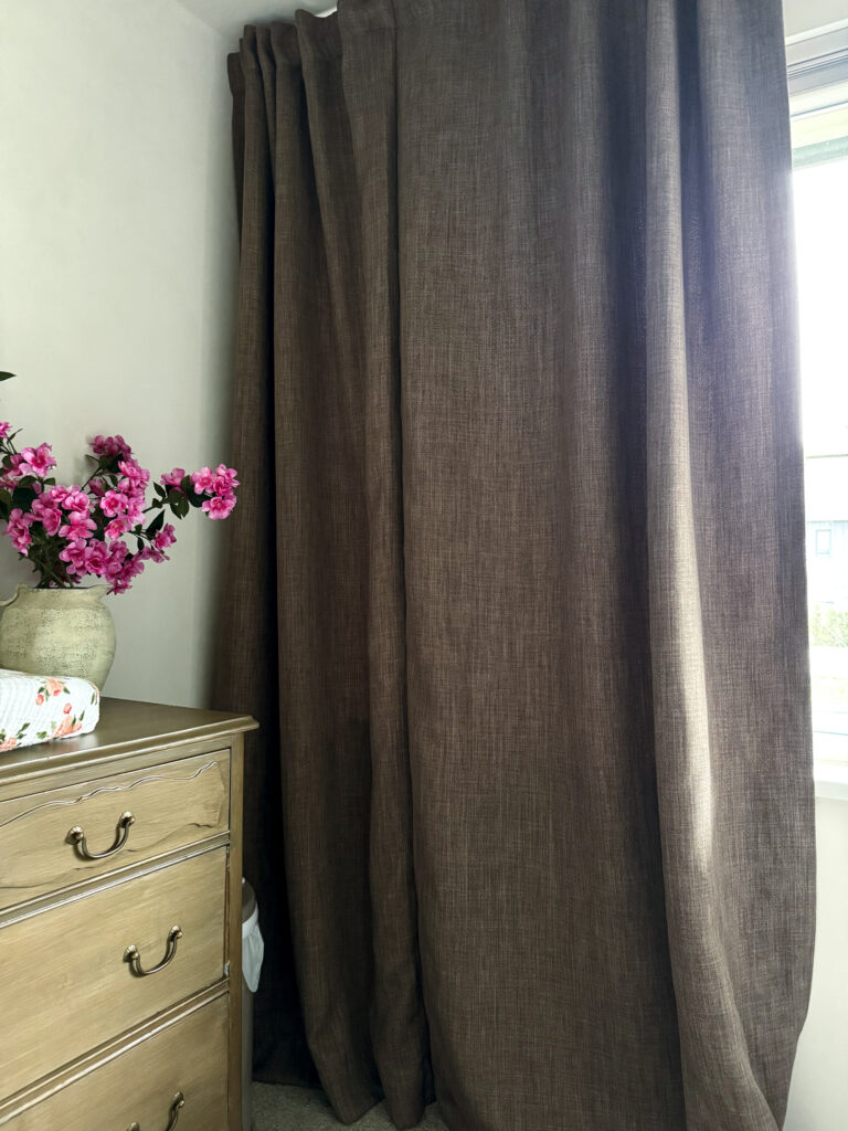 Making your curtains look expensive - a nursery with brown curtains and a dresser as a change table
